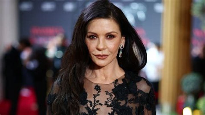 Catherine Zeta-Jones Looks Gorgeous In Black Dress With High Slit At Golden Globes