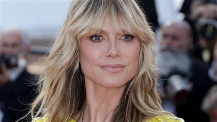 Heidi Klum, 50, Rocks Cutout Floral Swimsuit While Serving Plates Of Food On Vacay: Photos